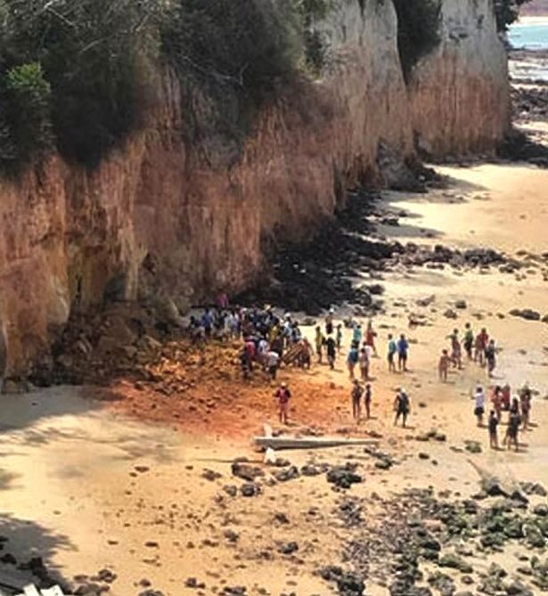 Witnesses said the mum tried to wrap her body around her son to shield him when she saw the cliff coming down