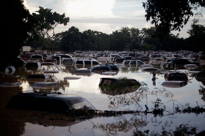 Vehicles are submerged at a plot flooded by the