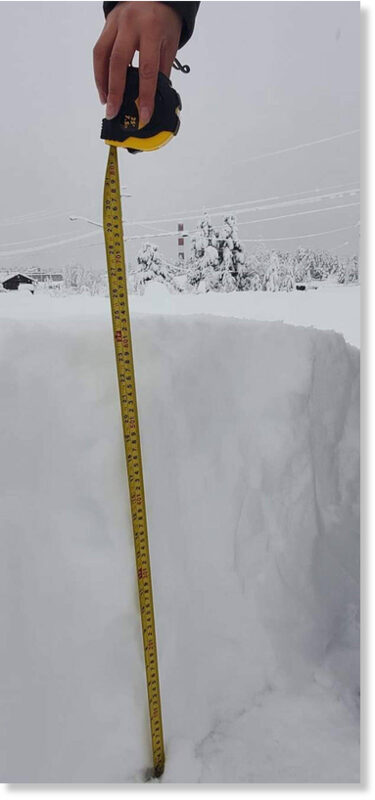 A member of Ulkatcho First Nation measures the snow on Friday, Nov. 27, 2020 showing that more than 60 cms of snow has fallen since a snowfall warning went into effect for northern portions of the Chilcotin on Thursday