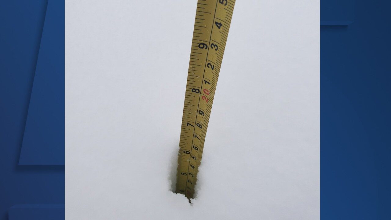 Click to enlarge Image of measuring tape in snow in Cuyahoga County from winter storm on Dec. 1, 2020.