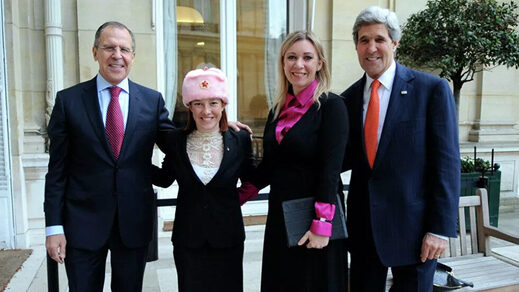 Then-State Department spokesperson Jen Psaki poses with her Russian counterpart Maria Zakharova, US Secretary of State John Kerry, and Russian Foreign Minister Sergey Lavrov, in Paris, January 13, 2014.