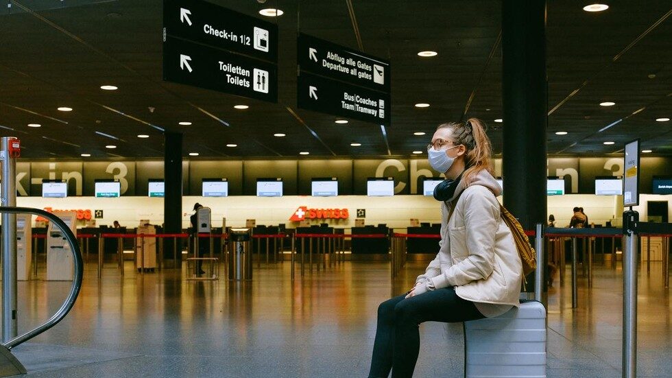 woman sitting airport with mask