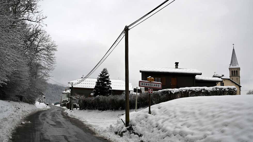This picture taken on Dec. 9, 2020, shows houses and a church under snow at the entrance of Bonvillard, France, where a helicopter crash left five dead with only the pilot surviving but badly wounded.