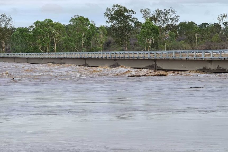 Floodwaters rise and swirl under Macrossan Bridge, north-east of Charters Towers.