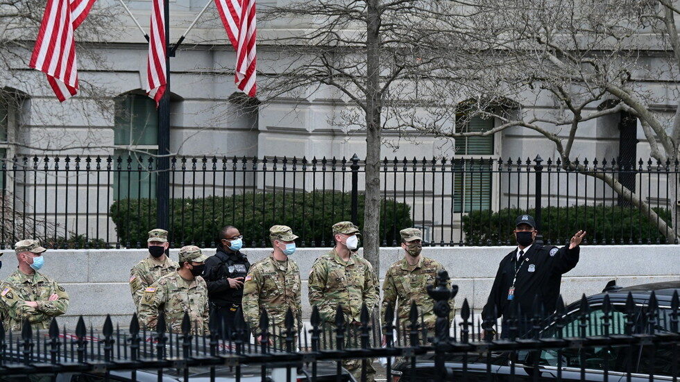 Secret Service members walk National Guard