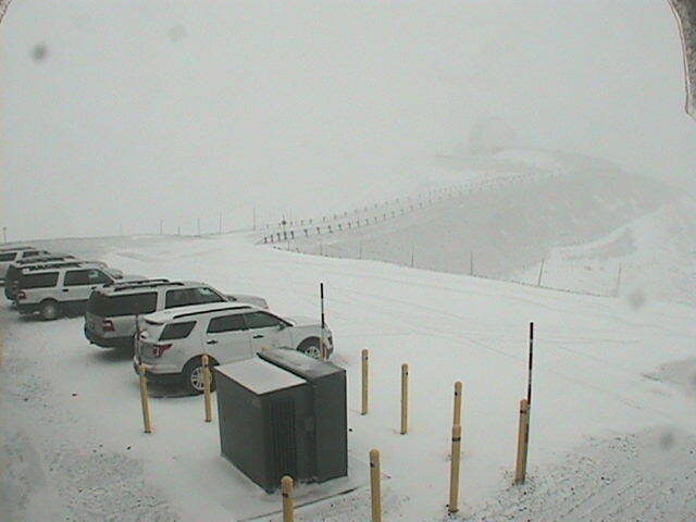 Click to enlarge This webcam photo by W.M. Keck Observatory shows a dusting of snow in the observatory parking lot on Maunakea.