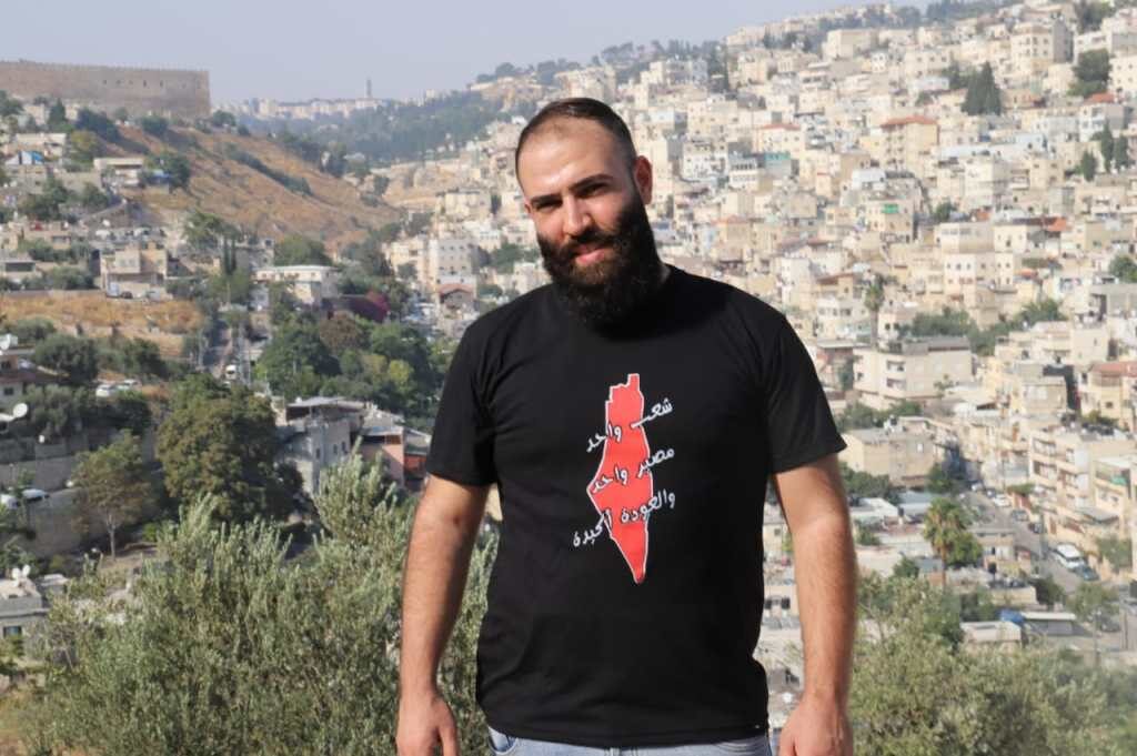 Click to enlarge Qutaibah Odeh and the town of Silwan i