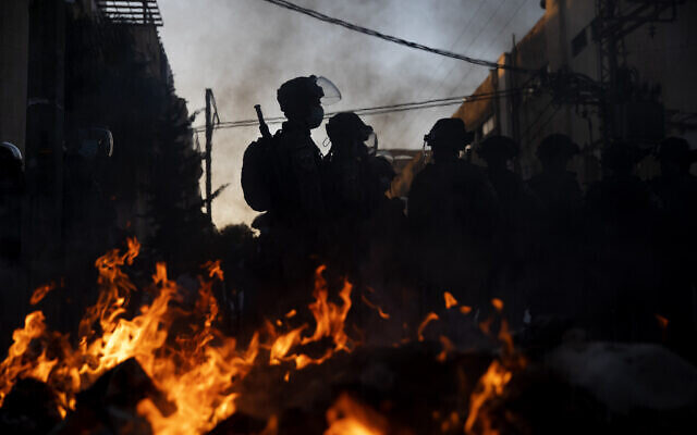 Click to enlarge Police near burning garbage