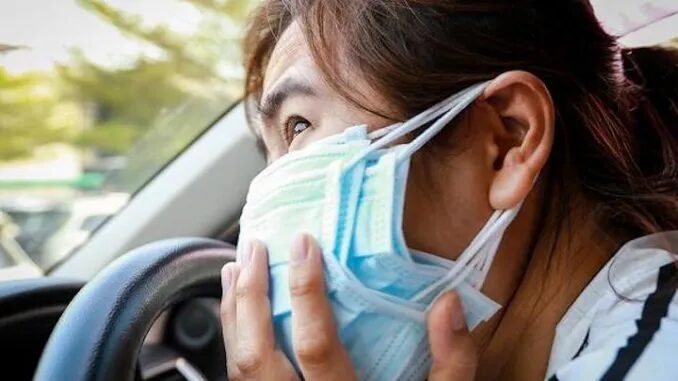 woman wearing four face masks, multiple masks
