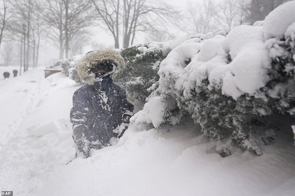 Arturo Diaz, 4, enjoys playing in a deep snow bank in Hoboken, New Jersey, on Monday