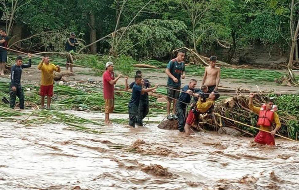 Rescuers brave floodwaters in Honduras to rescue people trapped by Hurricane Eta’s rains on November 6, 2020