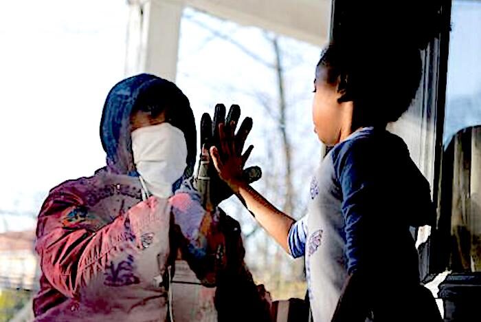 Hands meeting through glass
