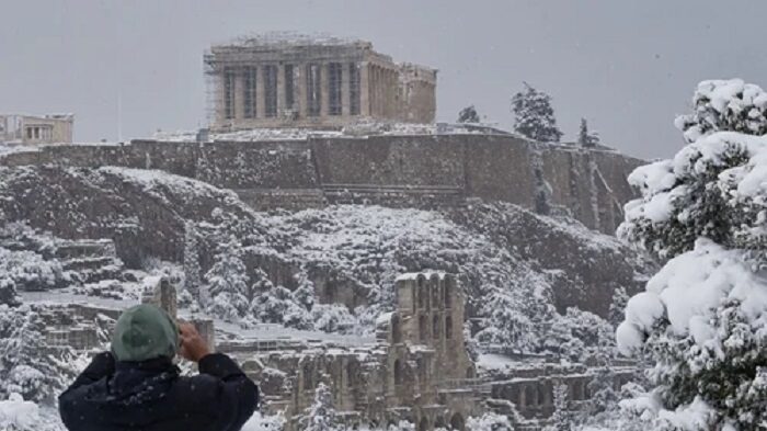 Click to enlarge The Parthenon temple on the Acropolis hill archaeological site during a heavy snowfall in Athens