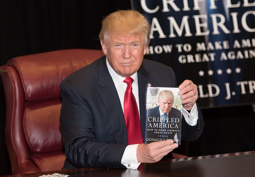 Click to enlarge Trump wth book