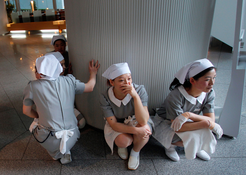 Hotel employees squat down