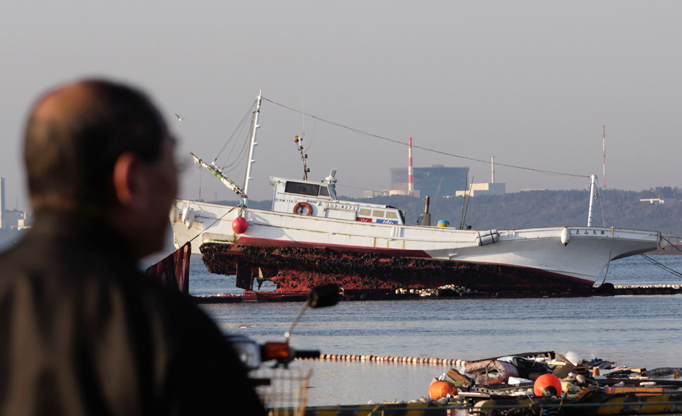 A man looks at a fishing boat