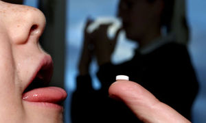 Click to enlarge Child taking a pill