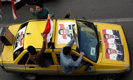 Click to enlarge Pro-Assad demonstrators in Syria