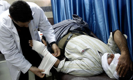 Click to enlarge doctor treating injured man