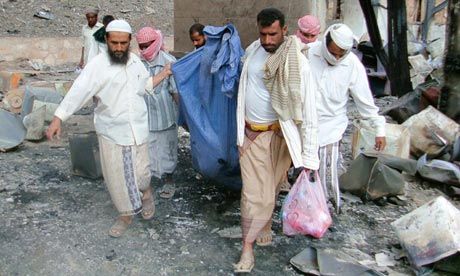 Click to enlarge people carry victim remains