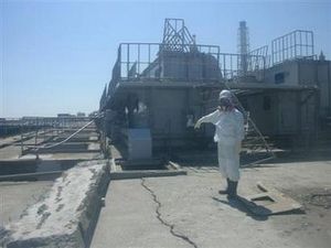 Click to enlarge worker wearing a protective suit