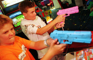 kids @ video game w/ guns