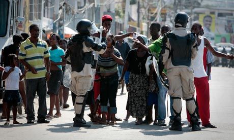 Click to enlarge Haitians plead with riot police
