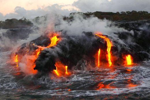 Click to enlarge Hot lava spills into the sea