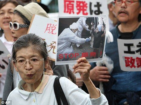 Click to enlarge A woman holds up a sign