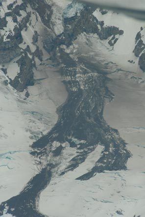 An aerial photograph shows the large rock/snow slide on Mount Rainier