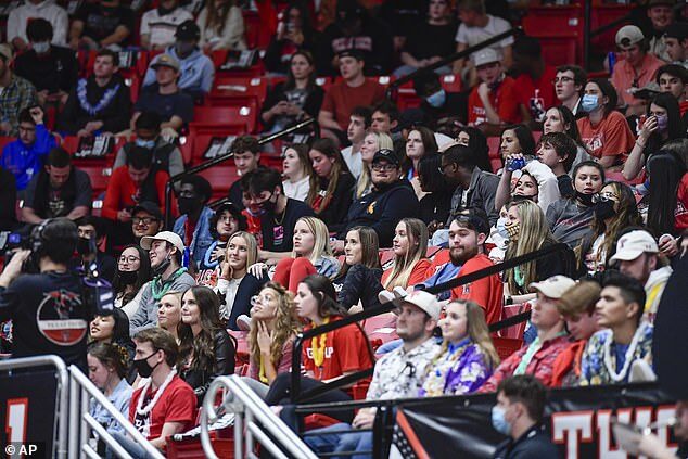 Click to enlarge Maskless students at basketball match