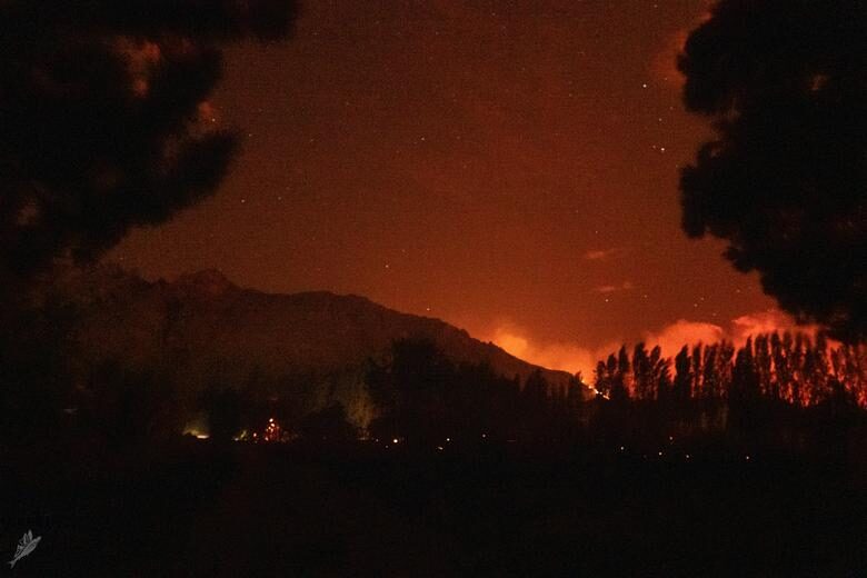 The sky glows orange as wildfires rage across