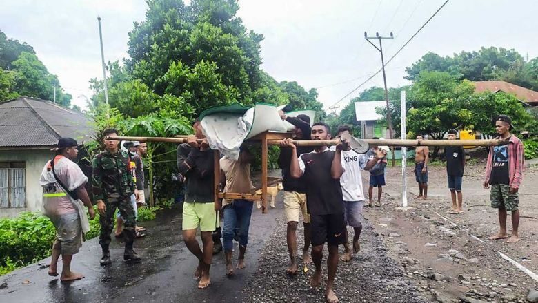 Villagers carry the body of a victim after flash floods in Lembata, East Flores, Indonesia on Monday.