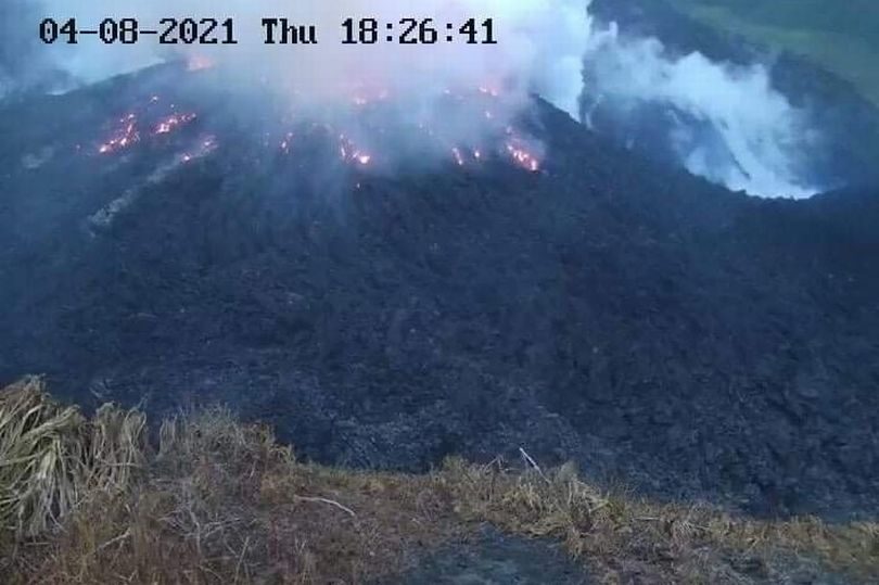 Smoke spews from the glowing dome of the La Soufriere volcano