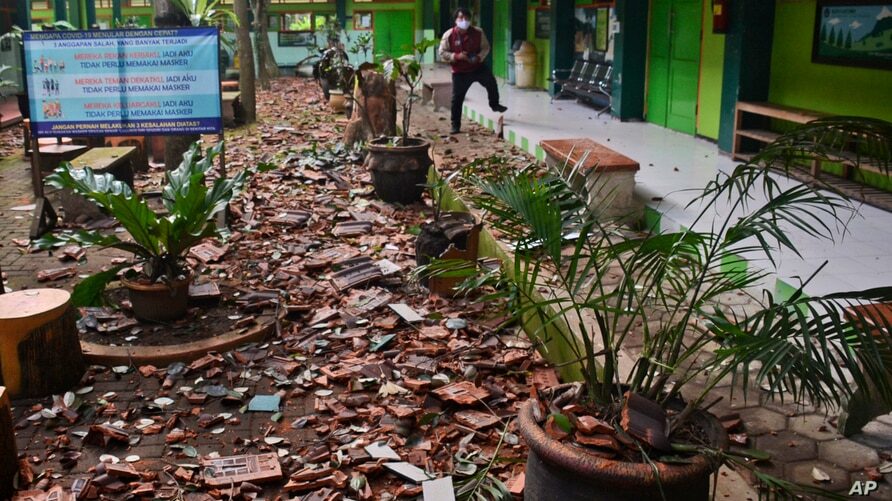 Pieces of roof tiles and other debris litter the ground at a school following an earthquake in Malang, East Java, Indonesia, April 10, 2021.