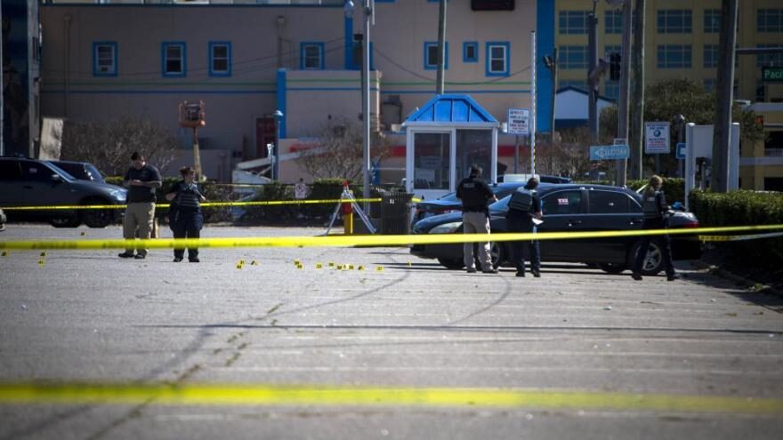 Click to enlarge Virginia Beach police work the scene of a shooting.
