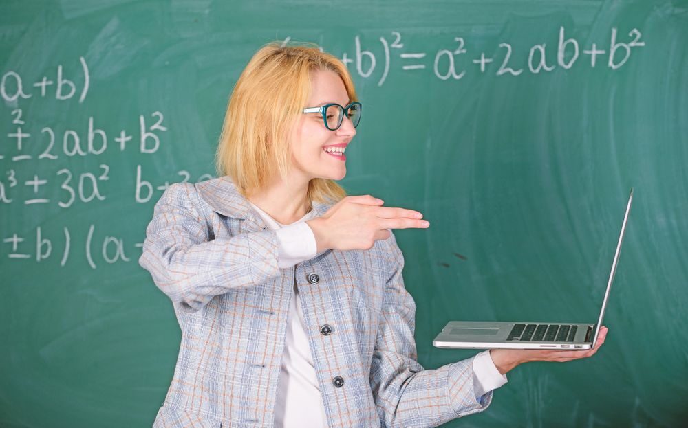 white teacher laptop blackboard