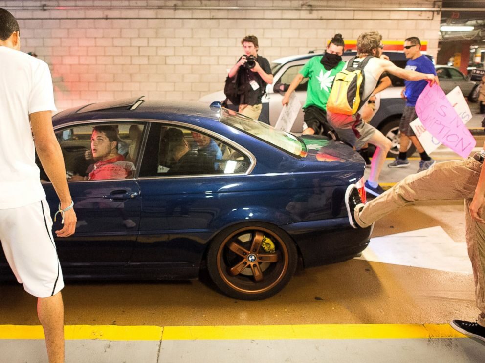Click to enlarge Protesters attack car
