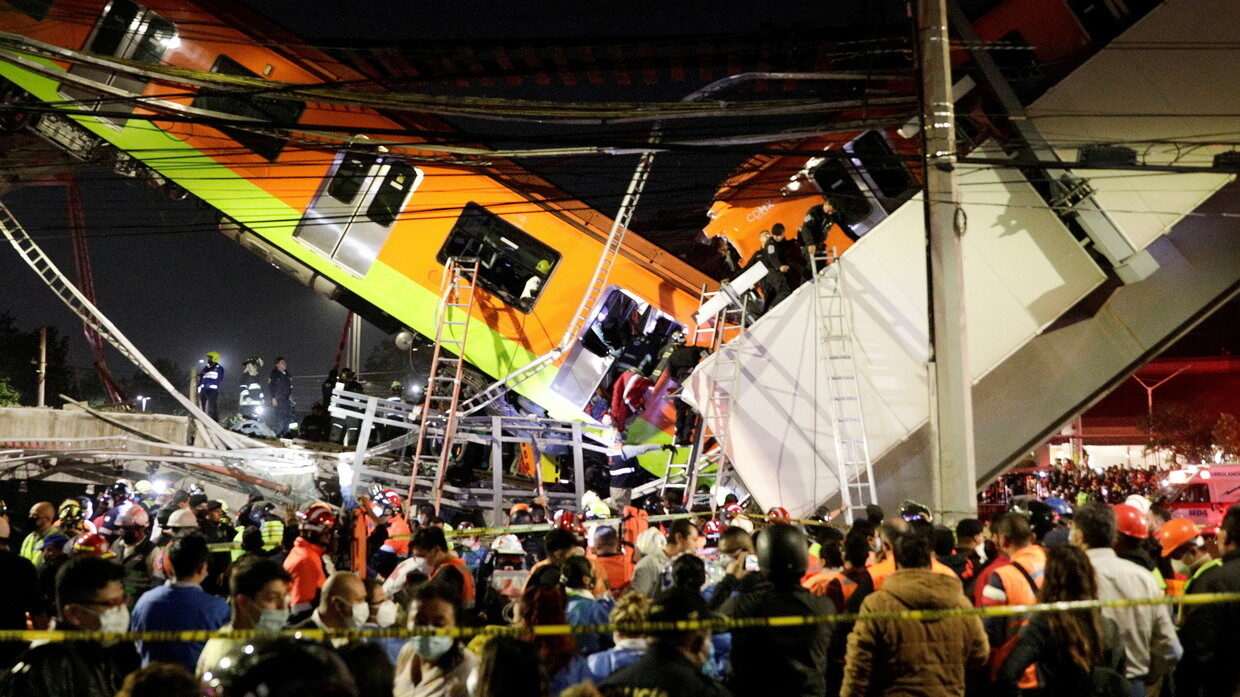 Rescuers work at a site where an overpass