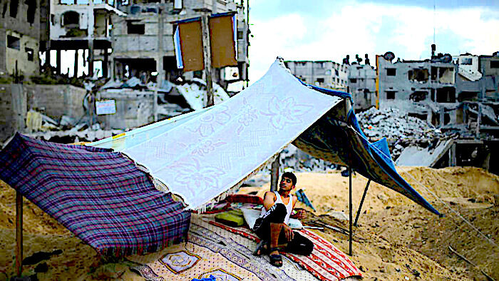 Man under makeshift tarp