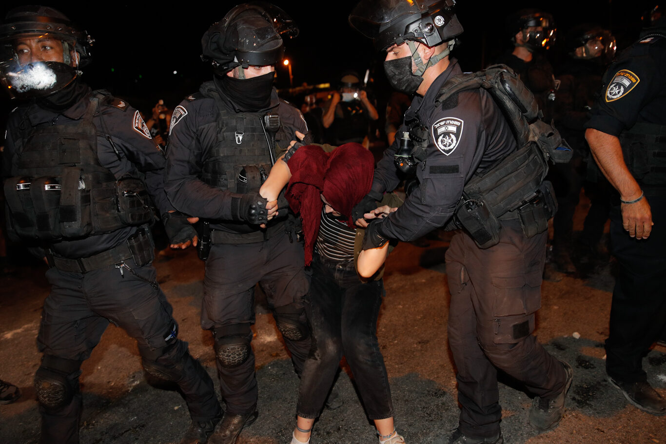 Israeli police grab a girl protesting the theft of Palestinian homes in Sheikh Jarrah, May 8, 2021.