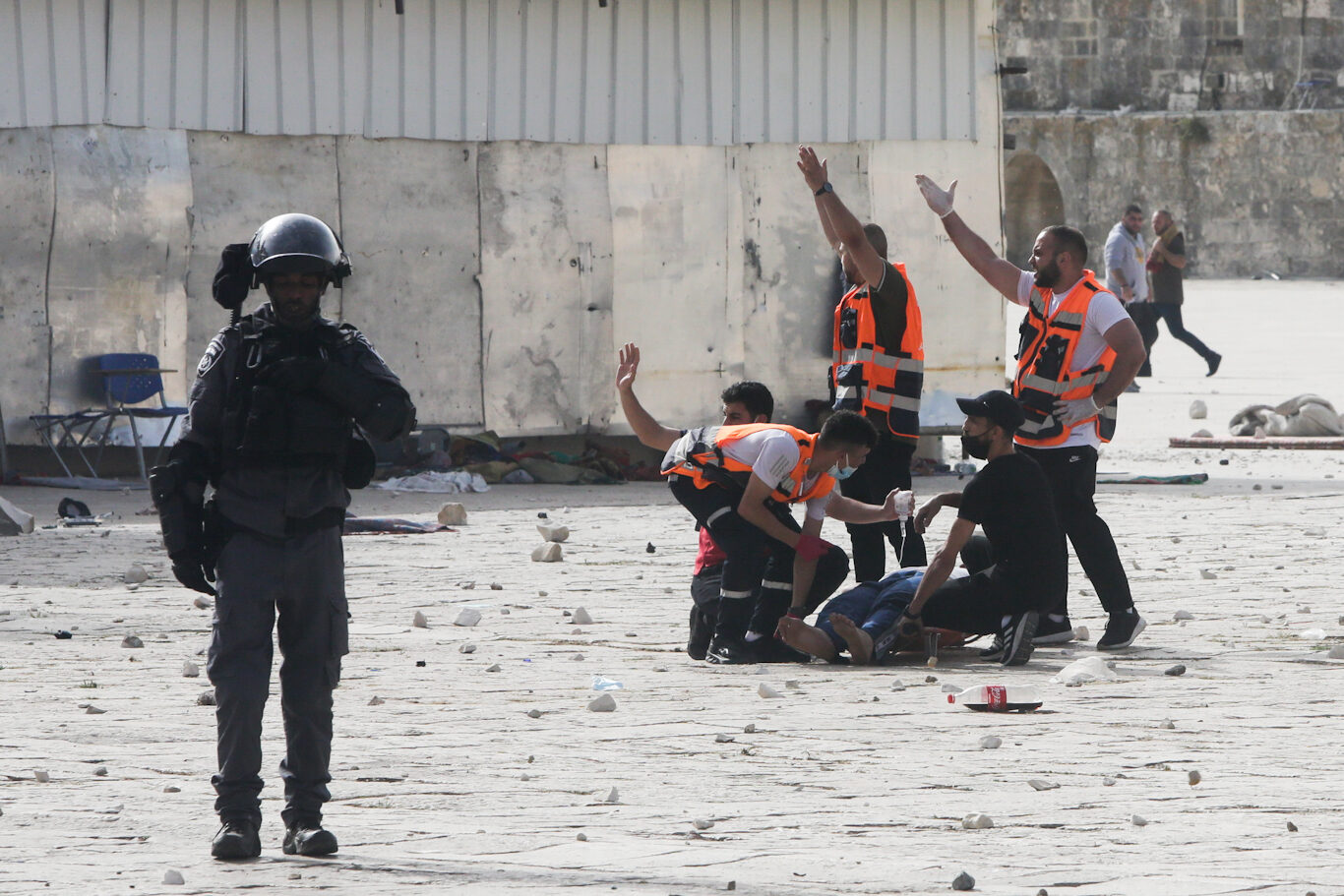 Medics treat a wounded by Israeli police at the Al Aqsa Mosque compound in Jerusalem, May 10, 2021