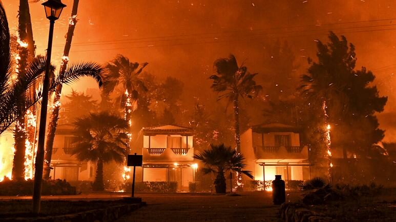 Click to enlarge Fire burns among houses during a wildfire in the village of Schinos, near Corinth, Greece, late Wednesday, May 19, 2021