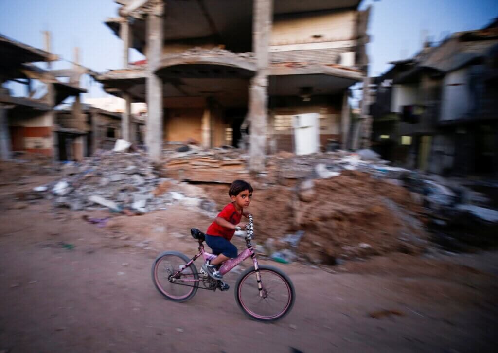 palestinian child bicycle gaza rubble