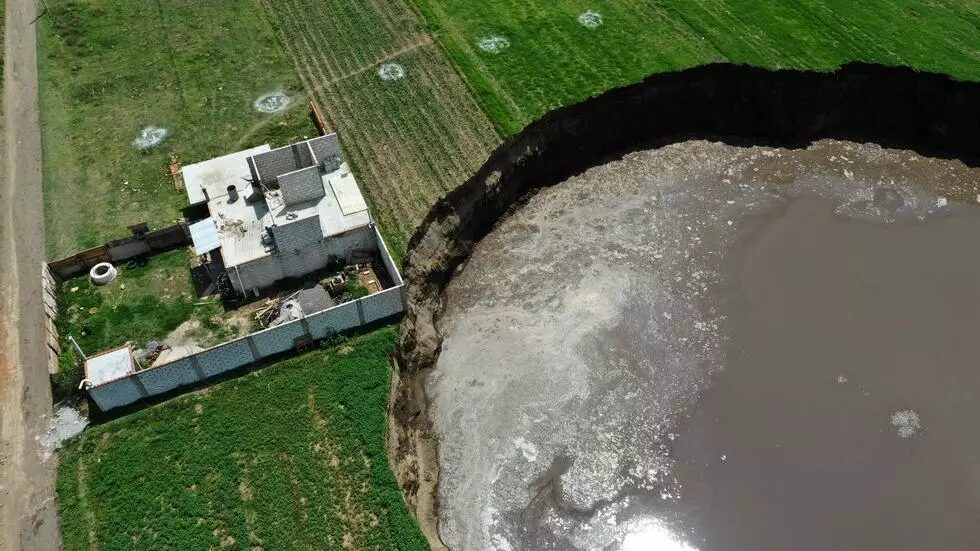 Click to enlarge A sinkhole is threatening to swallow a house in the Mexican state of Puebla