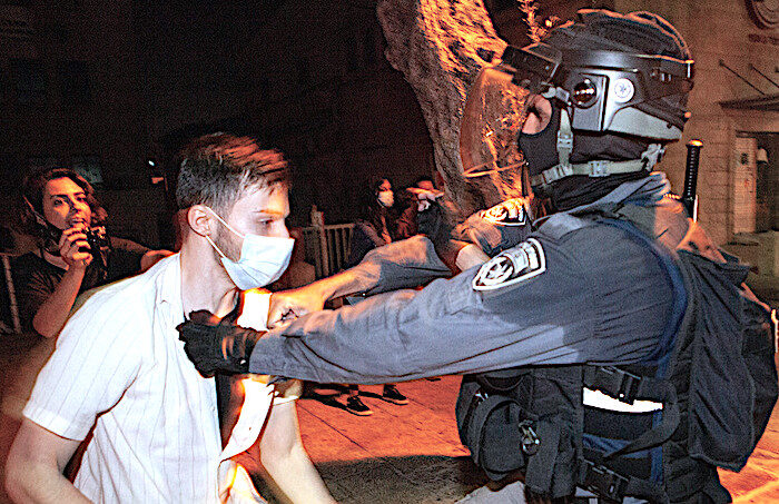Click to enlarge Protester/Israeli police
