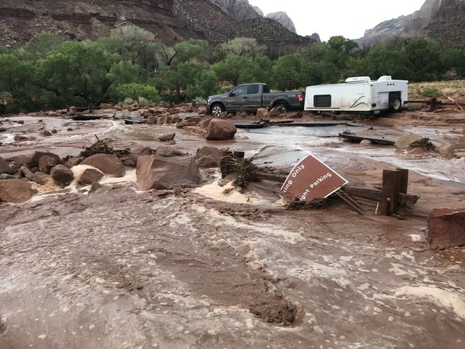 An overturned sign at Zion amid flooding Tuesday.