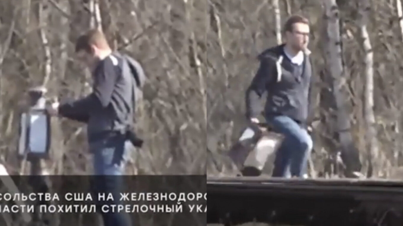 American embassy employee stealing railway sign