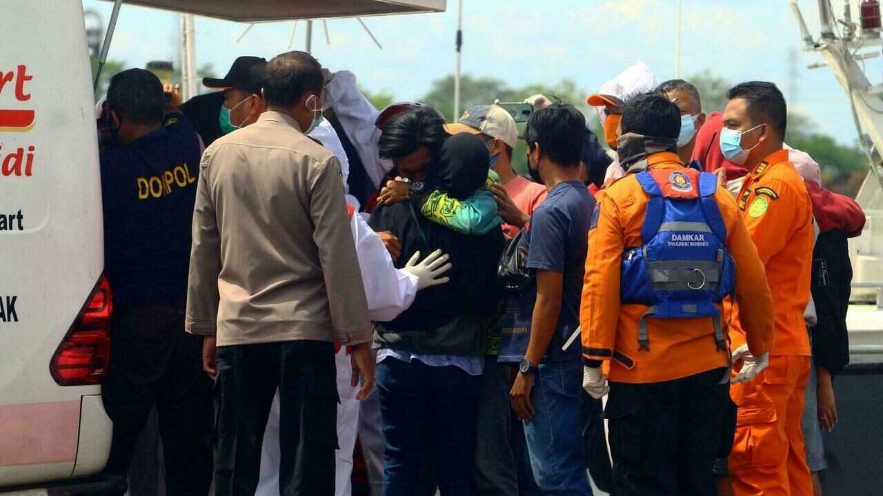 Click to enlarge Rescuers prepare to head out to search for survivors after a string of boats capsized during the storm