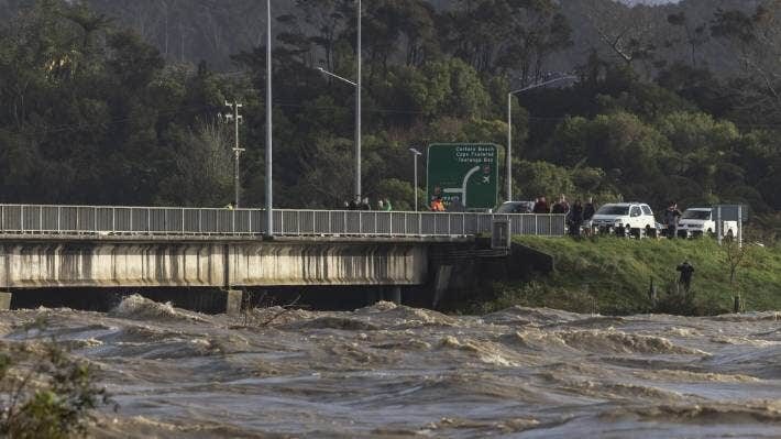 Click to enlarge Locals view the rising water at the Buller bridge in Westport on July 17.